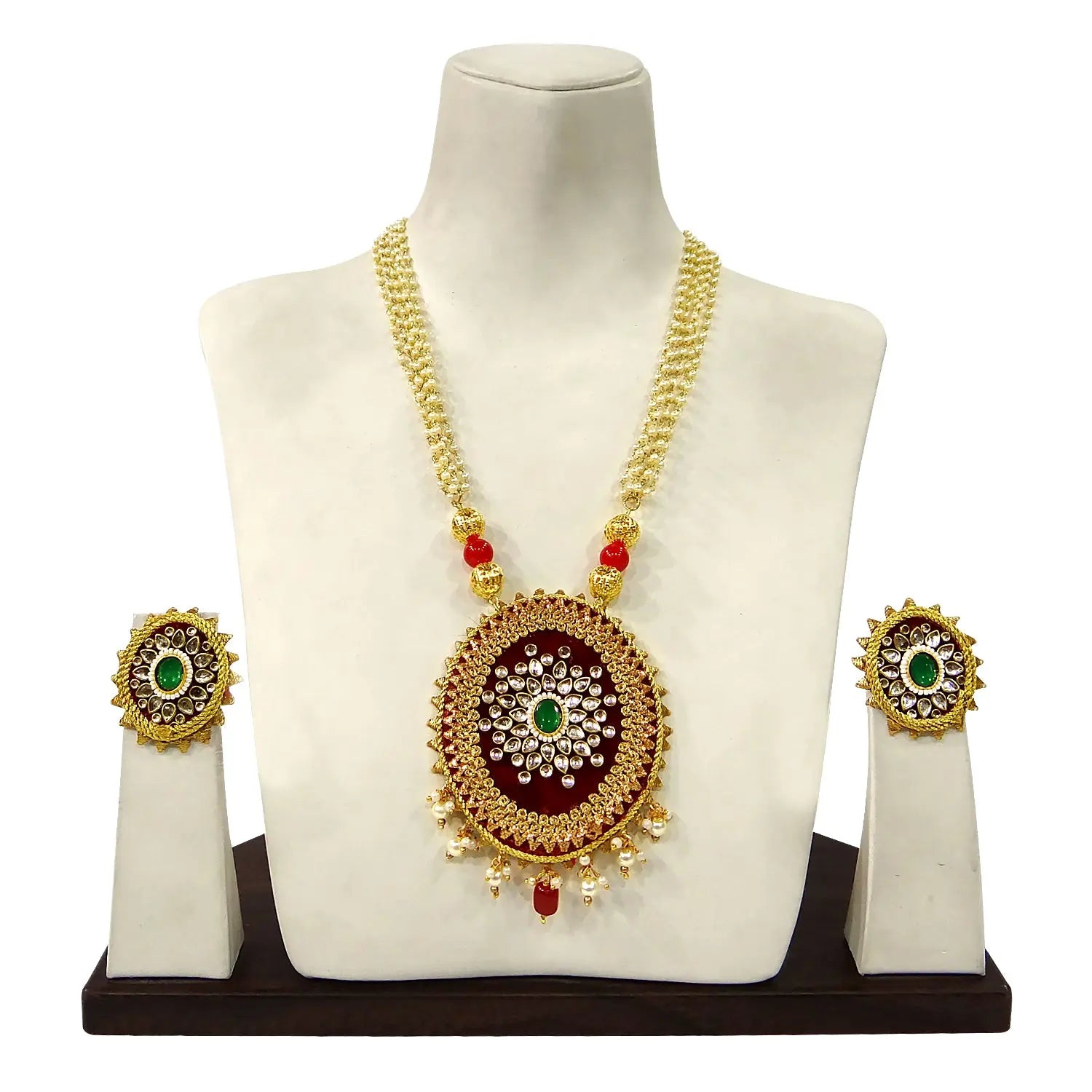 Gold necklace with pendant and earrings on a mannequin bust