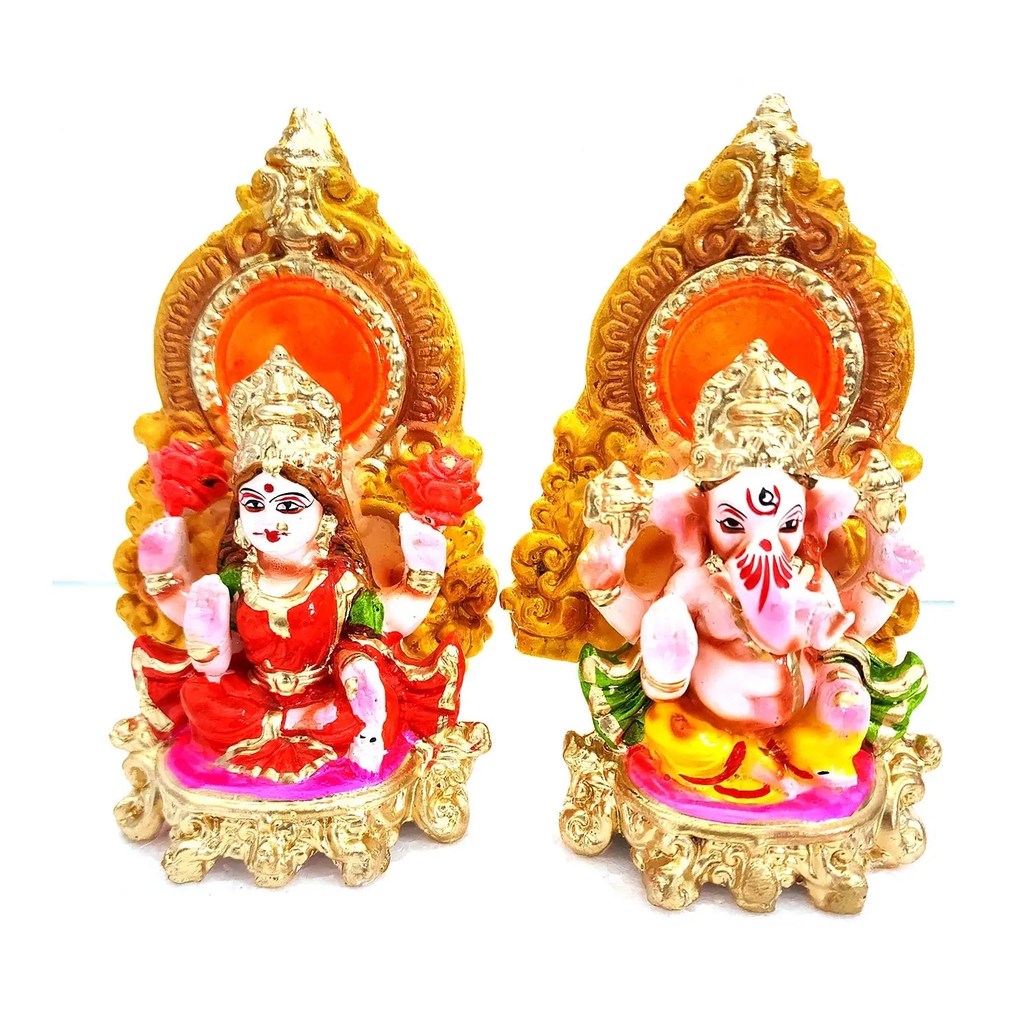 Two colorful figurines of a deity and a child on ornate thrones with gold accents.
