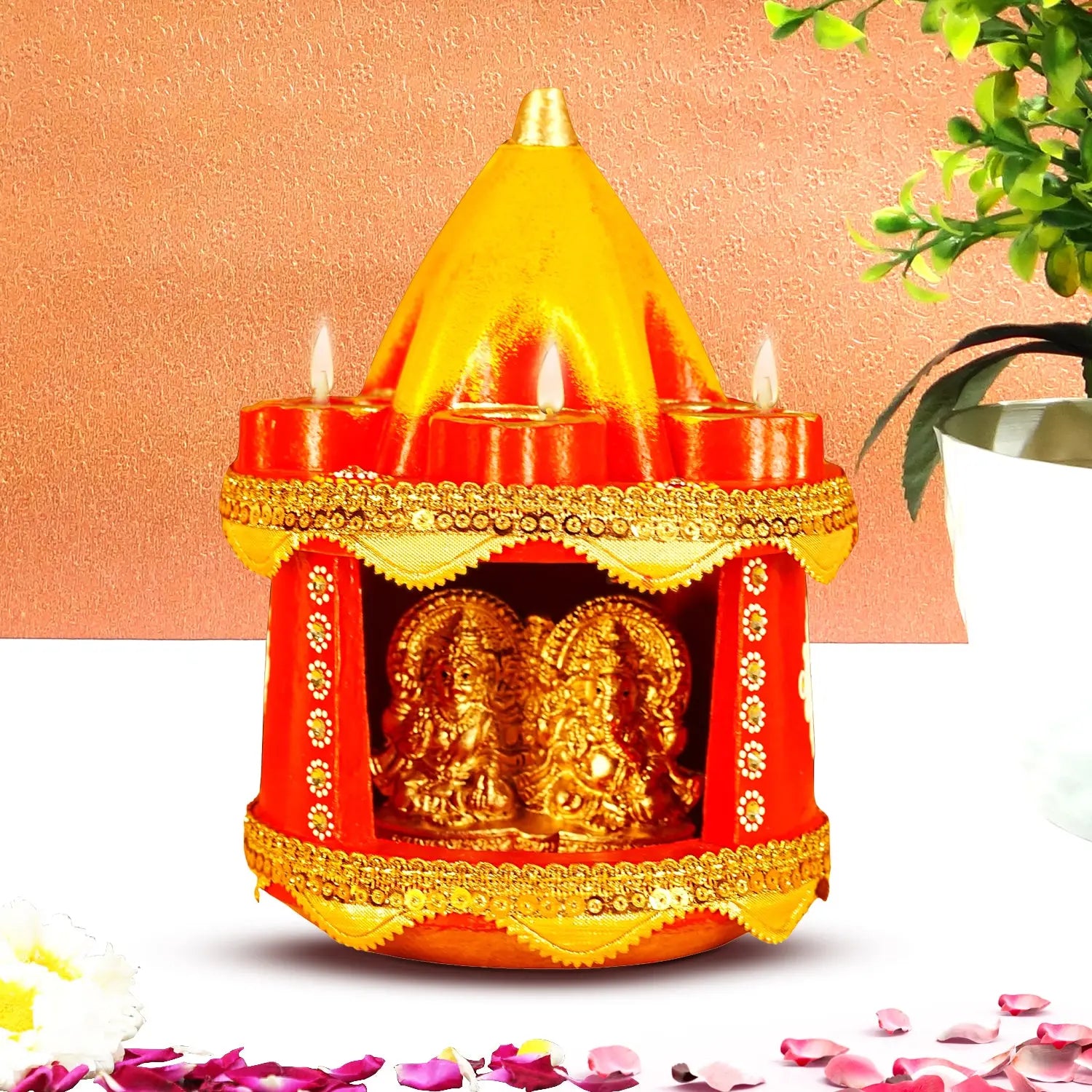 Decorative oil lamp with gold figures inside on a peach background