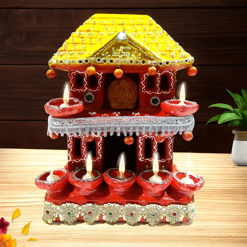 Decorative house-shaped lamp with lit candles on a wooden surface
