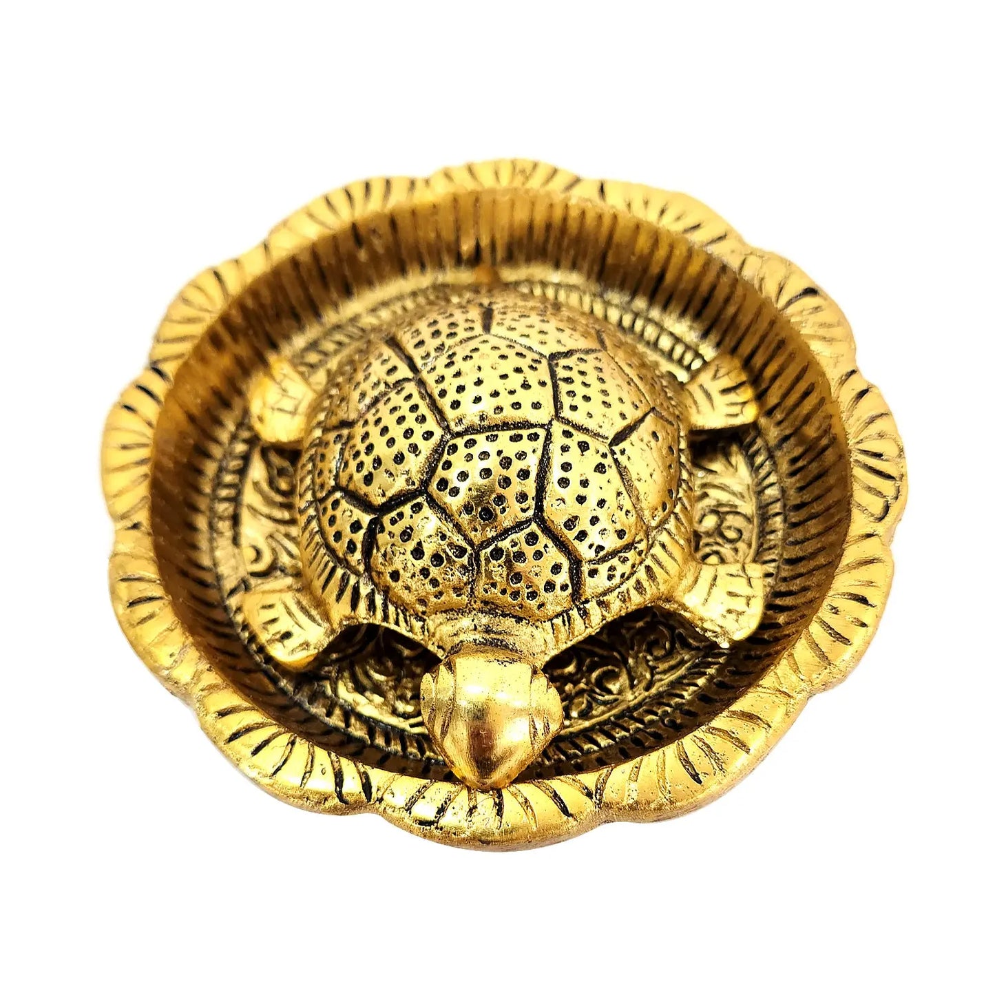 Gold decorative item with intricate design on a white background
