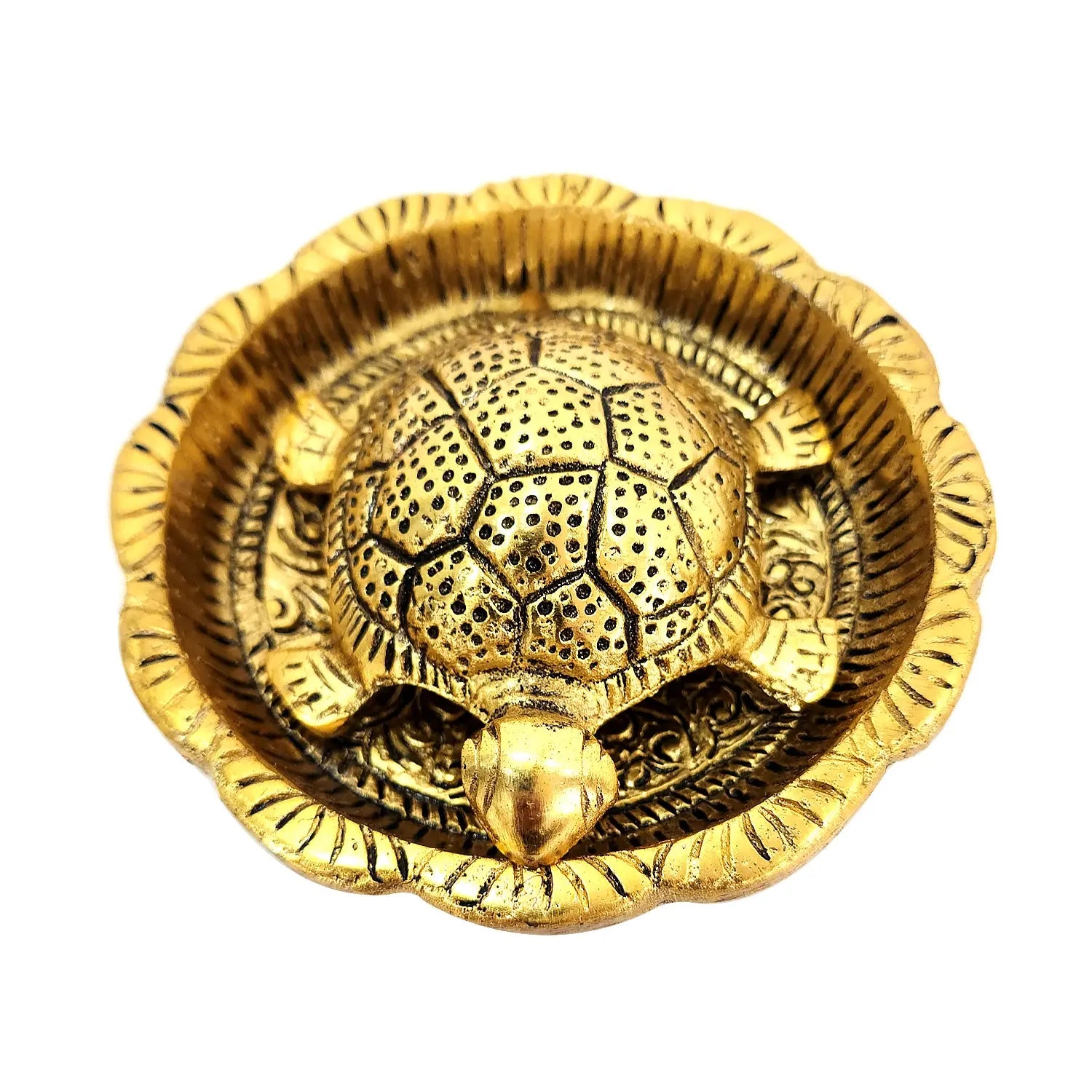 Gold decorative item with intricate design on a white background