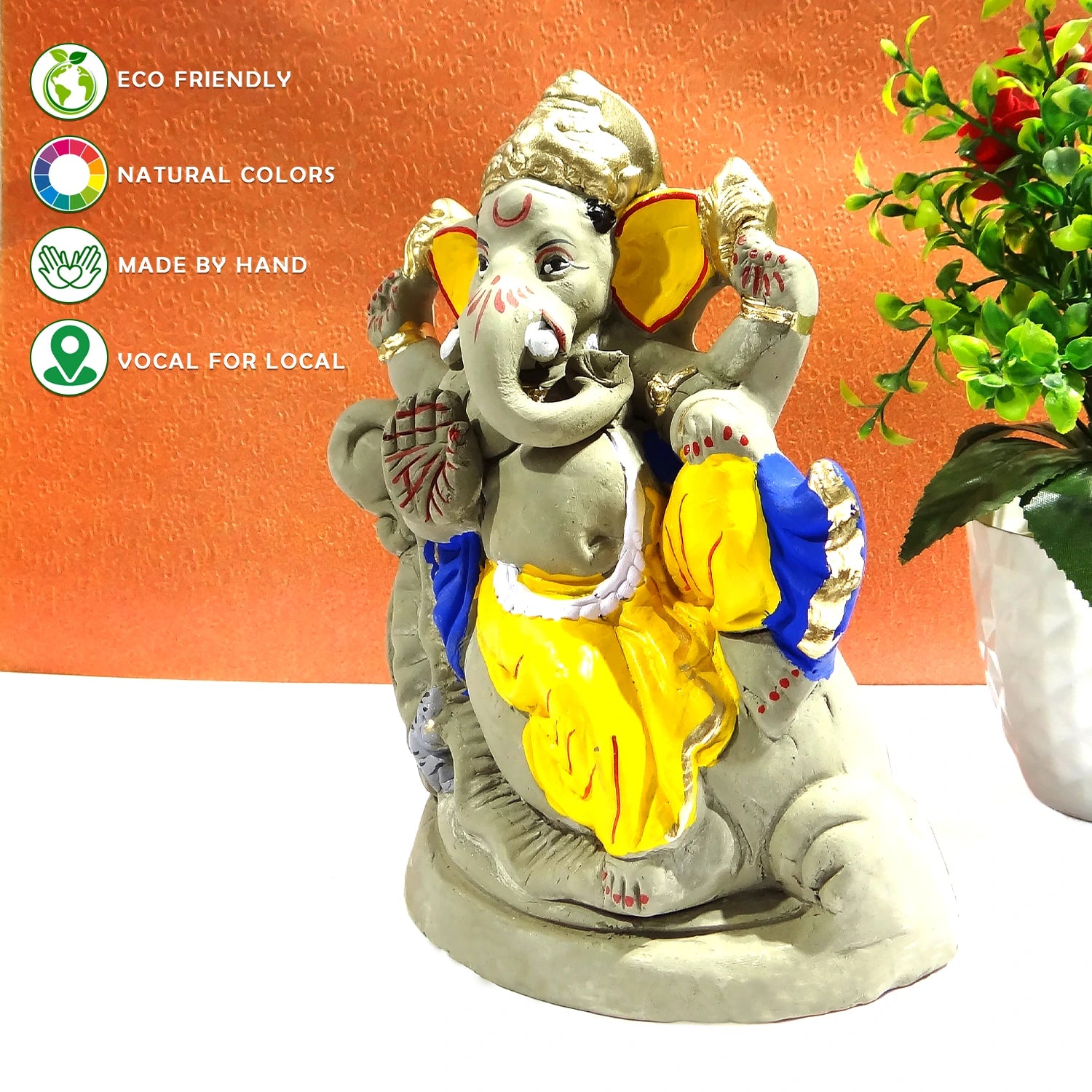 Decorative statue of a神灵 figure with eco-friendly and handcrafted attributes on an orange background.