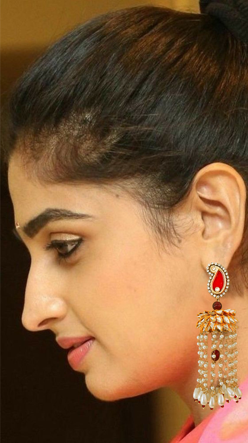 Close-up of a woman's ear with a gold earring against a blurred background
