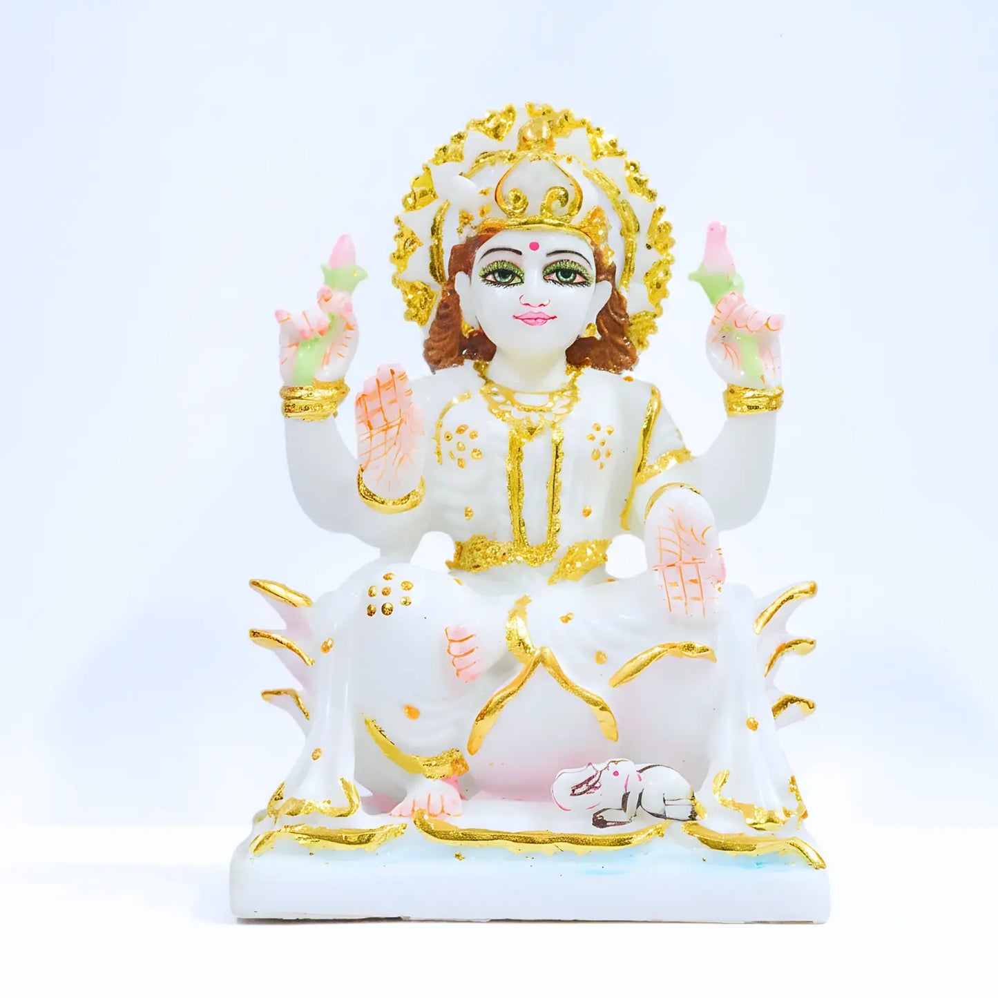 Decorative statue of a deity with gold and white colors on a light blue background