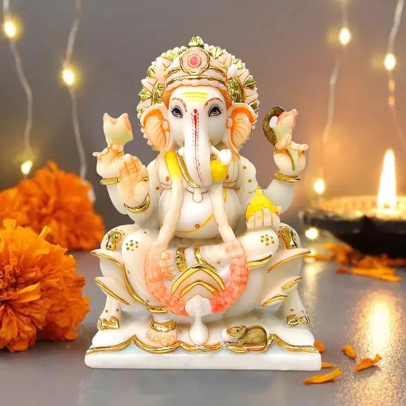 Decorative statue of Ganesha with flowers and lights in the background