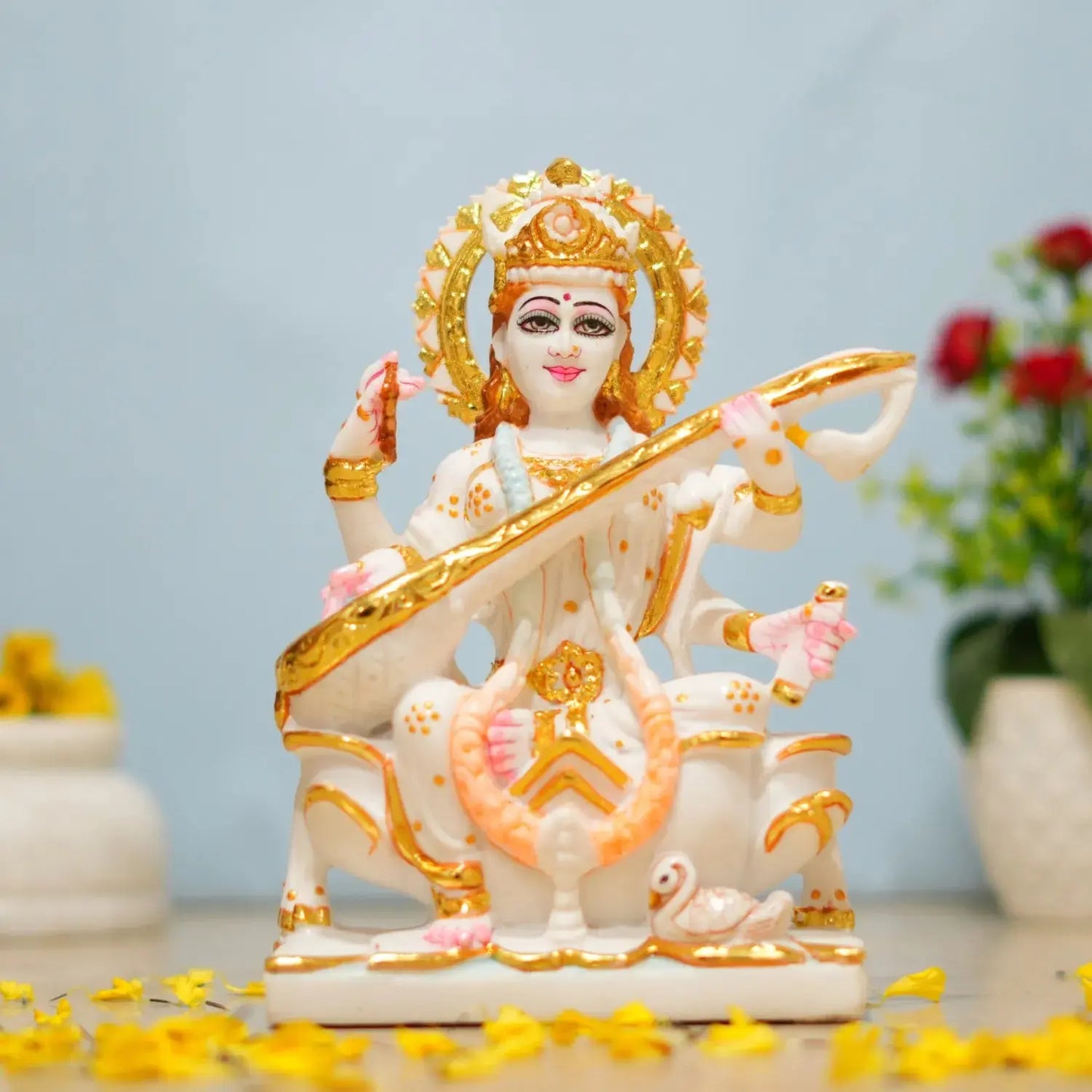 Colorful figurine of a deity with a blurred background