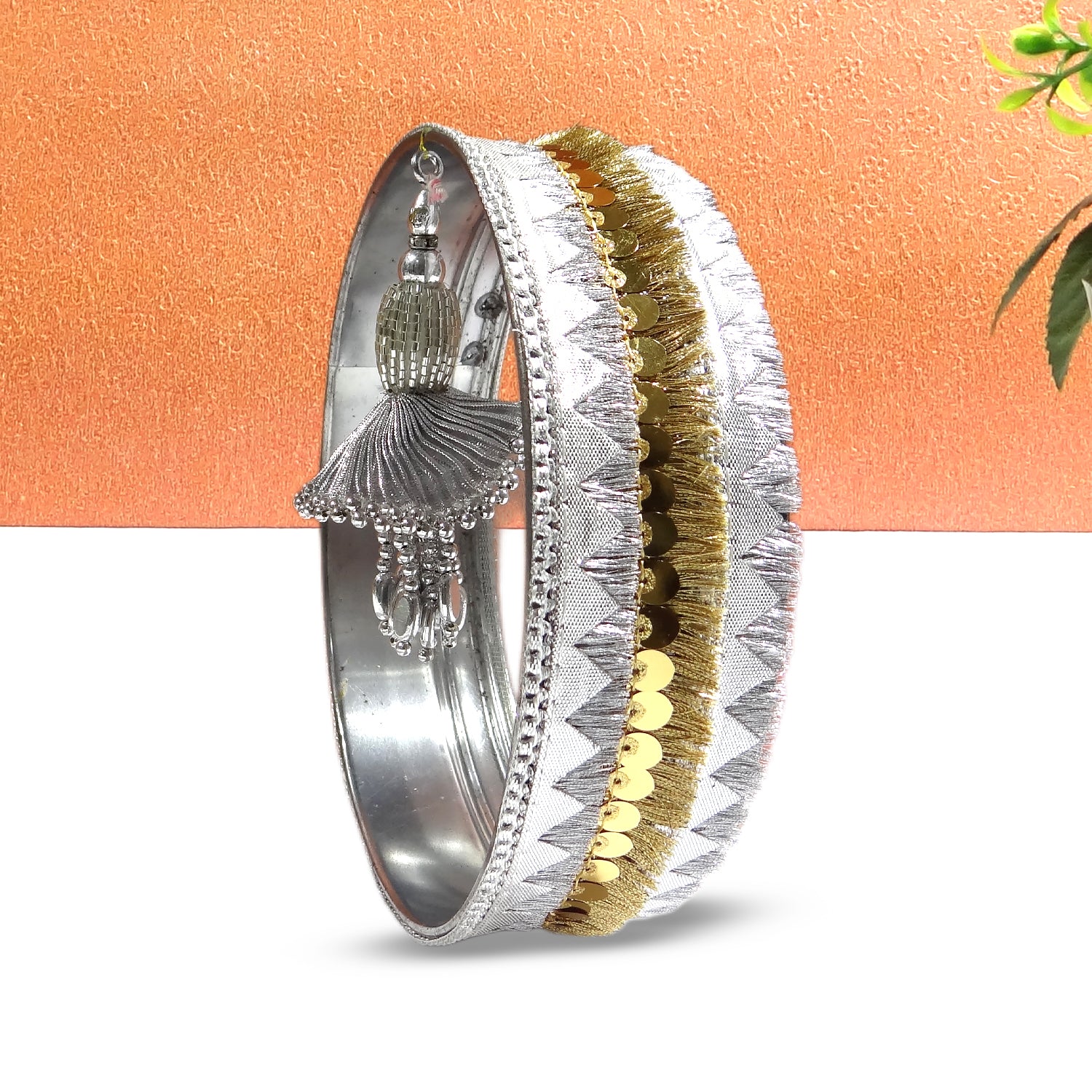 Decorative bangles with intricate designs on a peach background