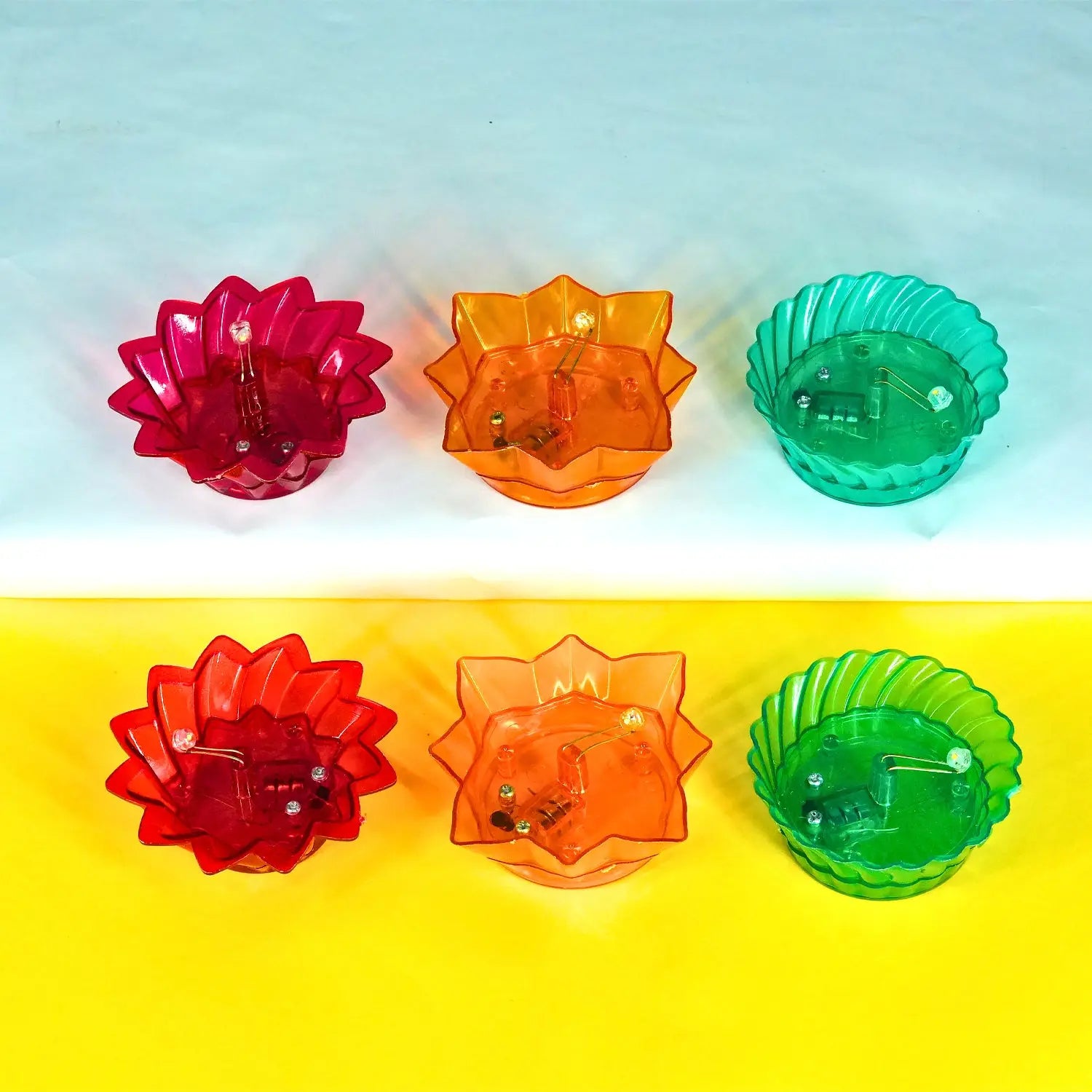 Set of five colorful transparent bowls on a gradient blue to yellow background