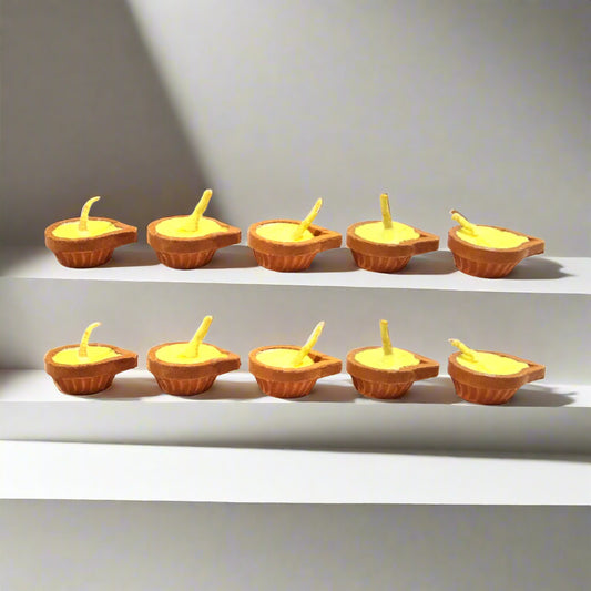 Small clay lamps with candles on a white background