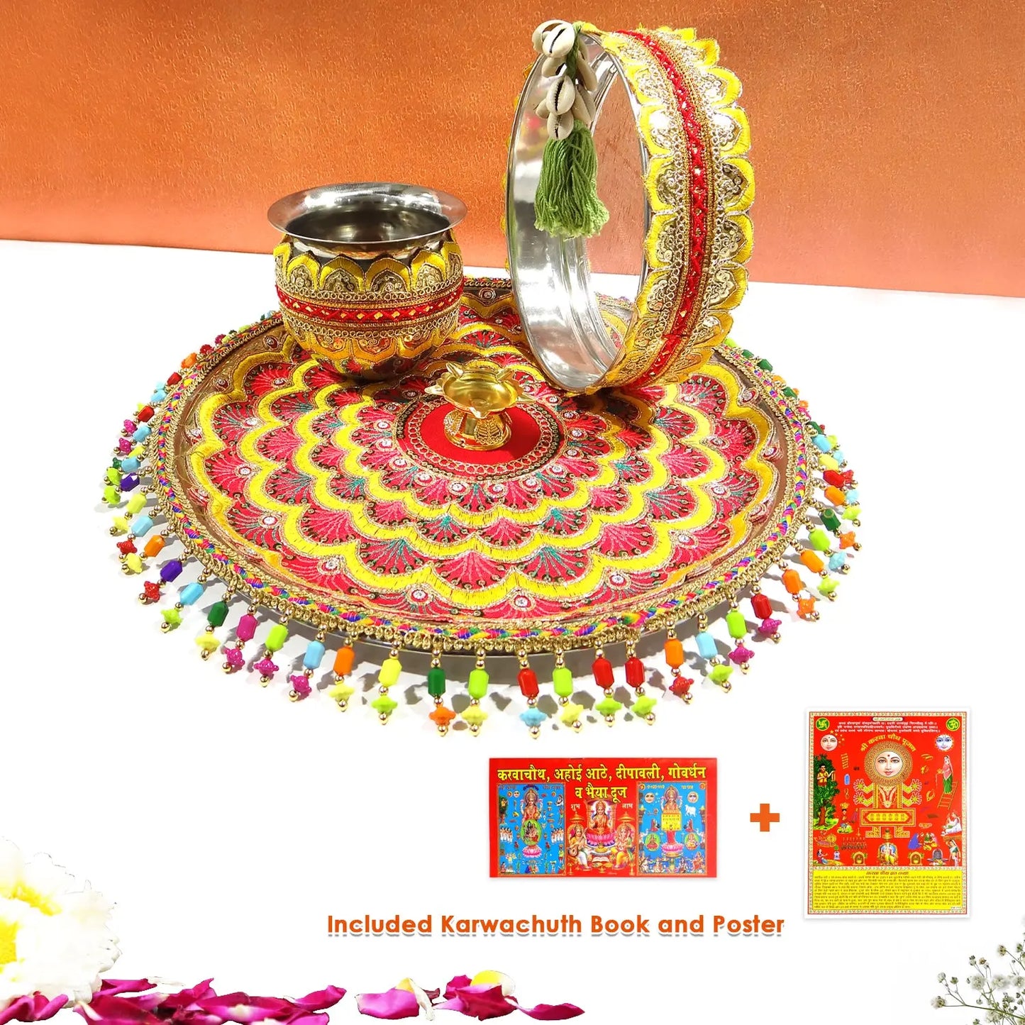 Decorative set with a red and gold circular design, silver cup, and bangles on an orange background.