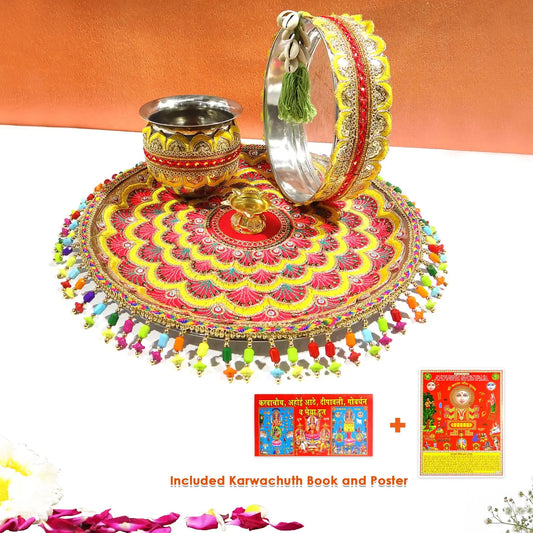 Decorative set with a red and gold circular design, silver cup, and bangles on an orange background.