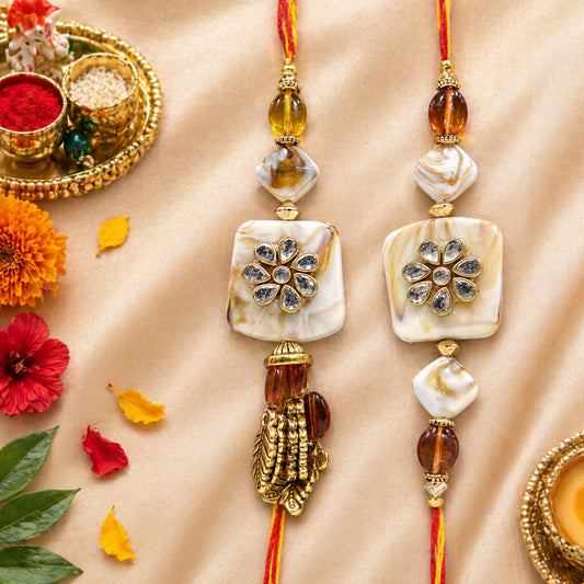 Exquisite Bhaiya-Bhabhi Lumba Rakhi Set with Kundan Flower Design & Golden Tassels By Uphakaro