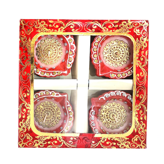 Decorative candles in a red and gold box with intricate patterns