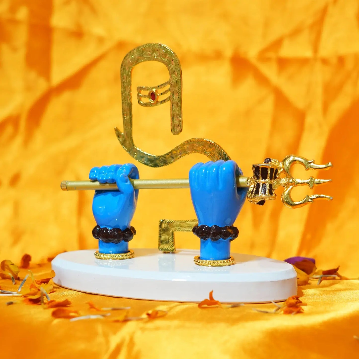 Decorative item with blue hands holding a golden trident on an orange background