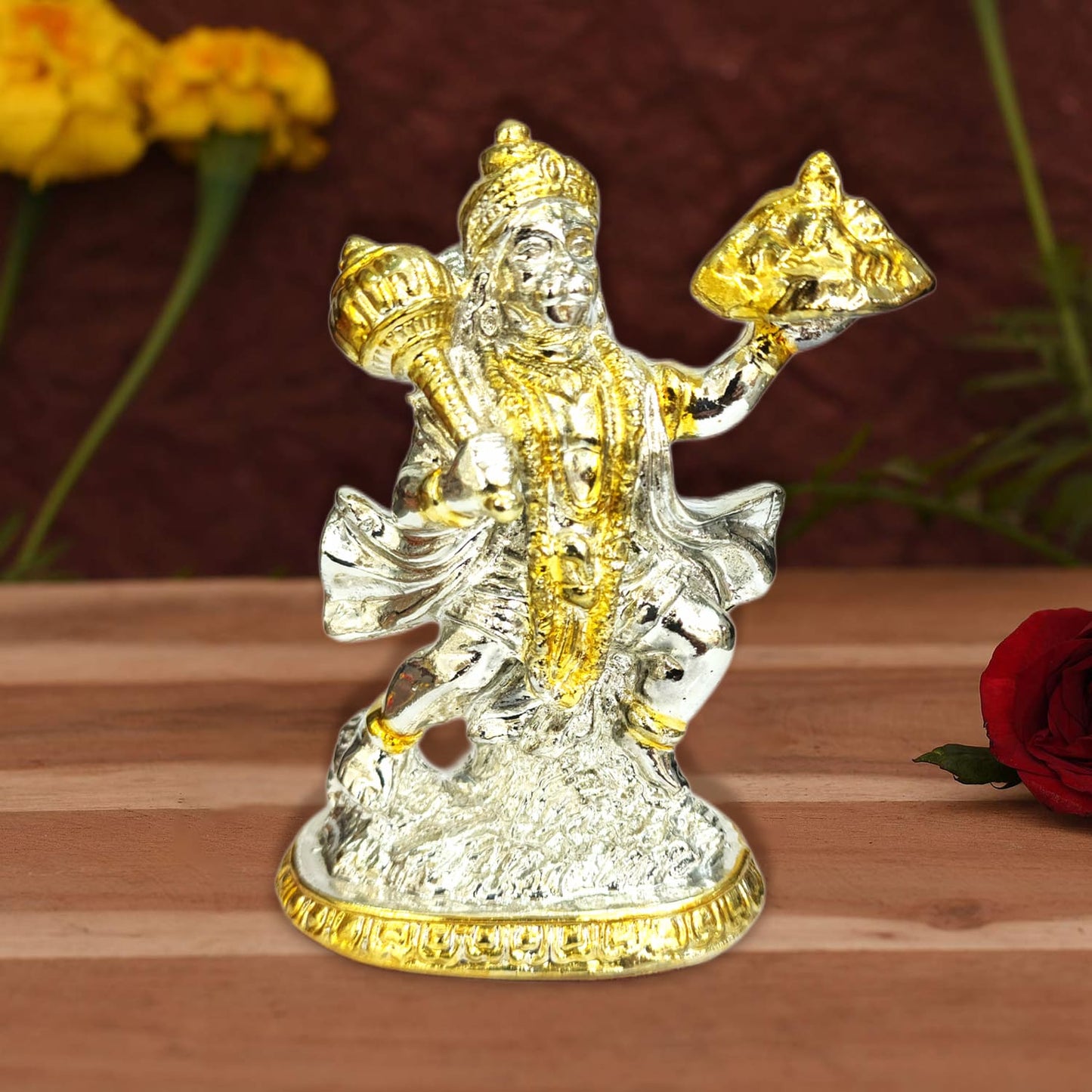 Silver-colored Hanuman Ji statue carrying a mountain, ideal for car dashboard or puja mandir, available online from Upharkaro.
