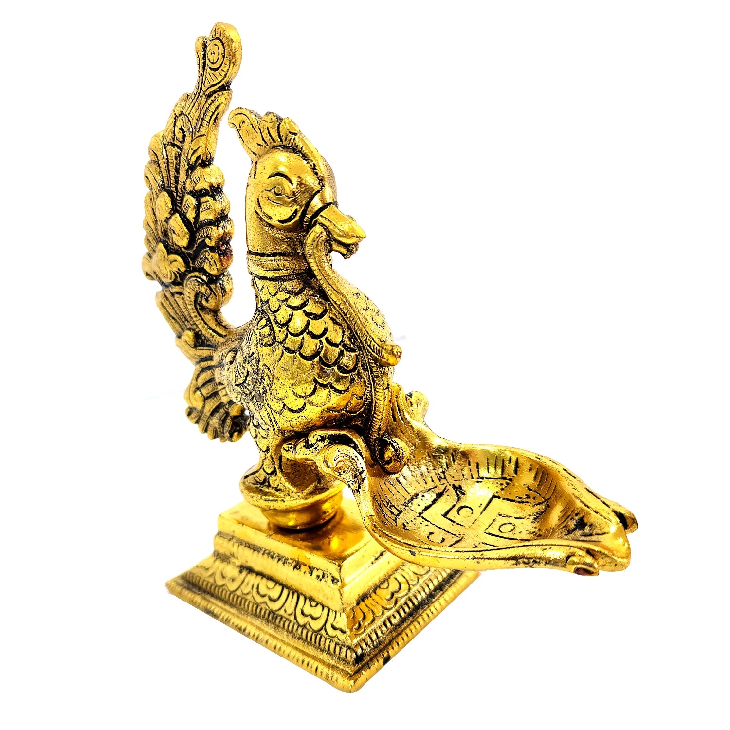 Gold-colored bird-like figurine on a white background