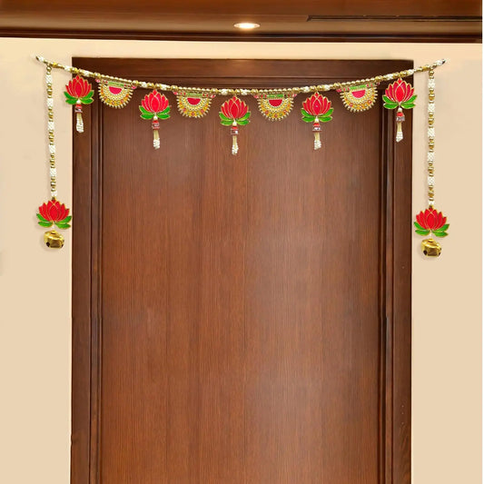 Decorative garland with red and gold elements hanging above a wooden door.