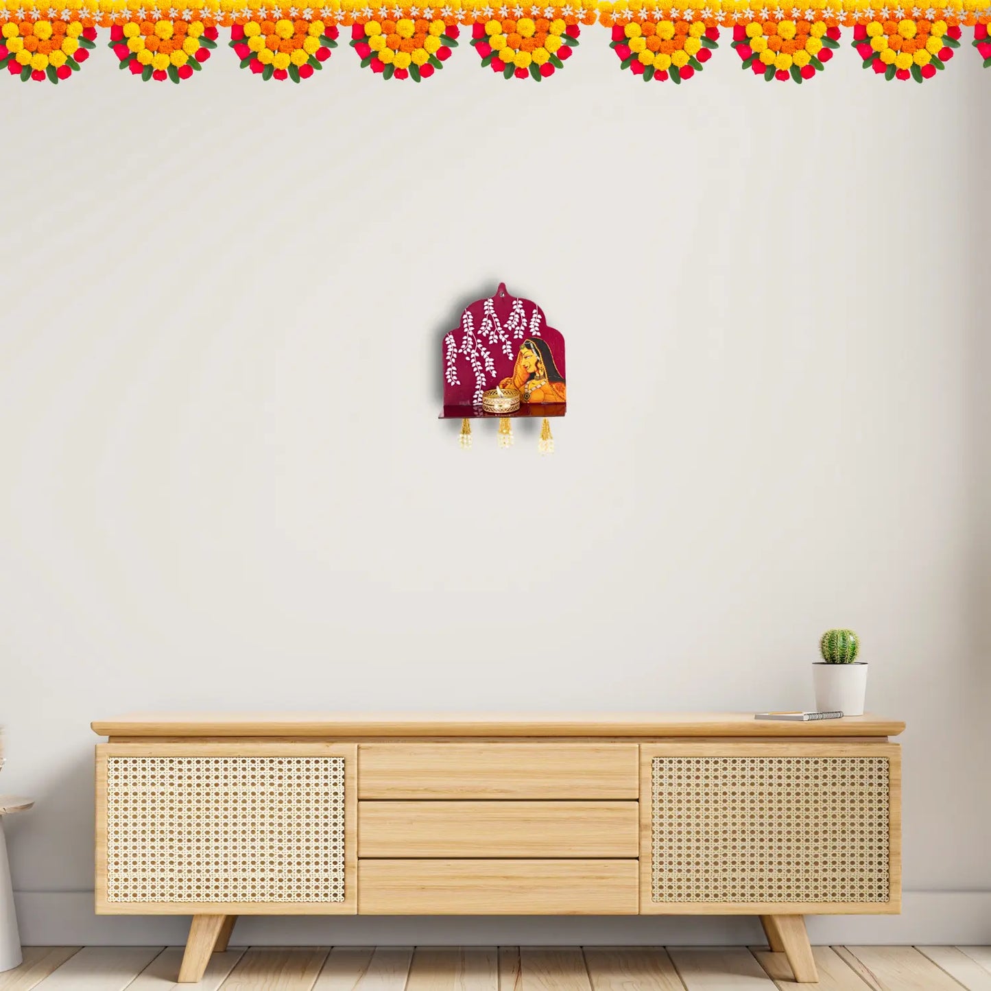 Wooden cabinet with decorative items against a white wall with floral border