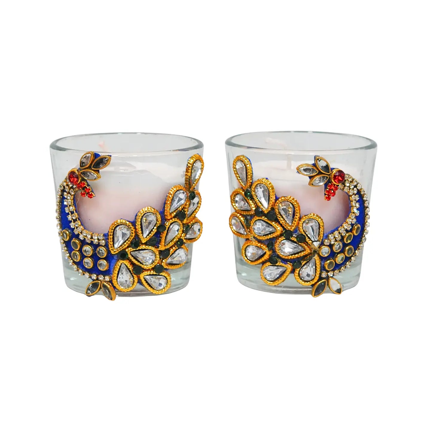 Two decorative glass candle holders with peacock feather designs on a white background