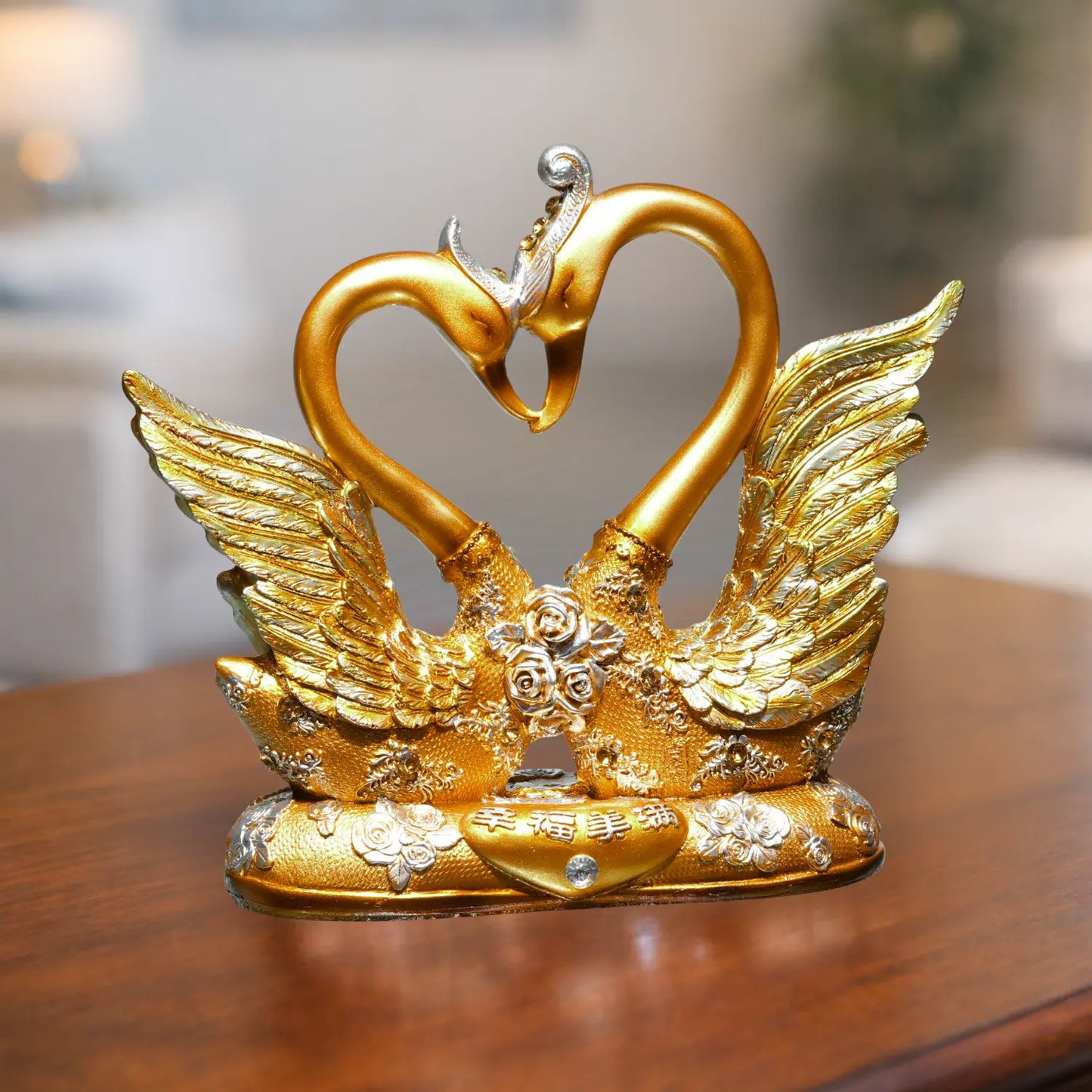 Gold swan figurine with heart-shaped neck on a wooden surface