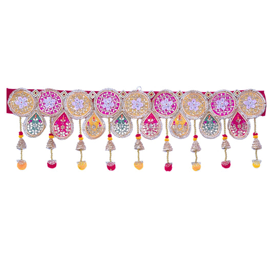 Decorative toran with colorful patterns and hanging elements on a white background