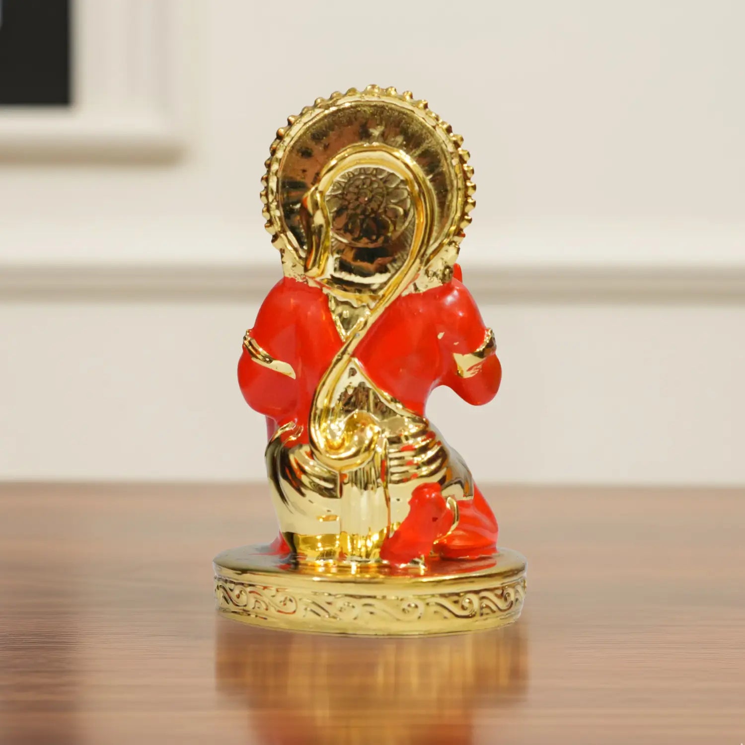 Decorative figure of a red and gold horse on a wooden surface