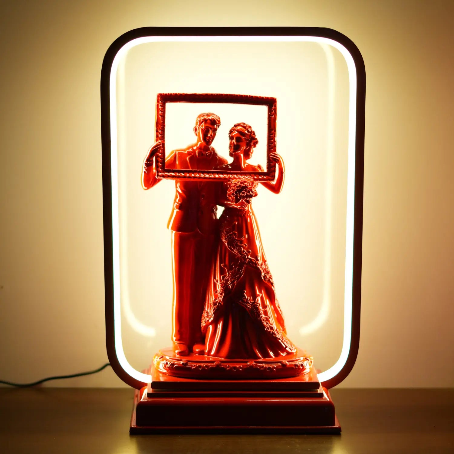 Decorative lamp with a couple holding a frame design on a beige background