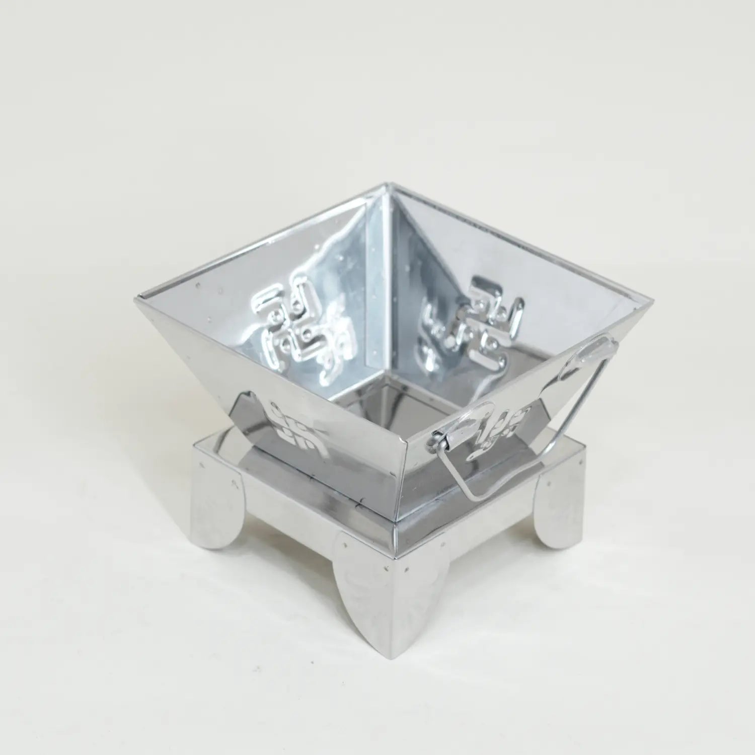 Metallic fire pit on a white background