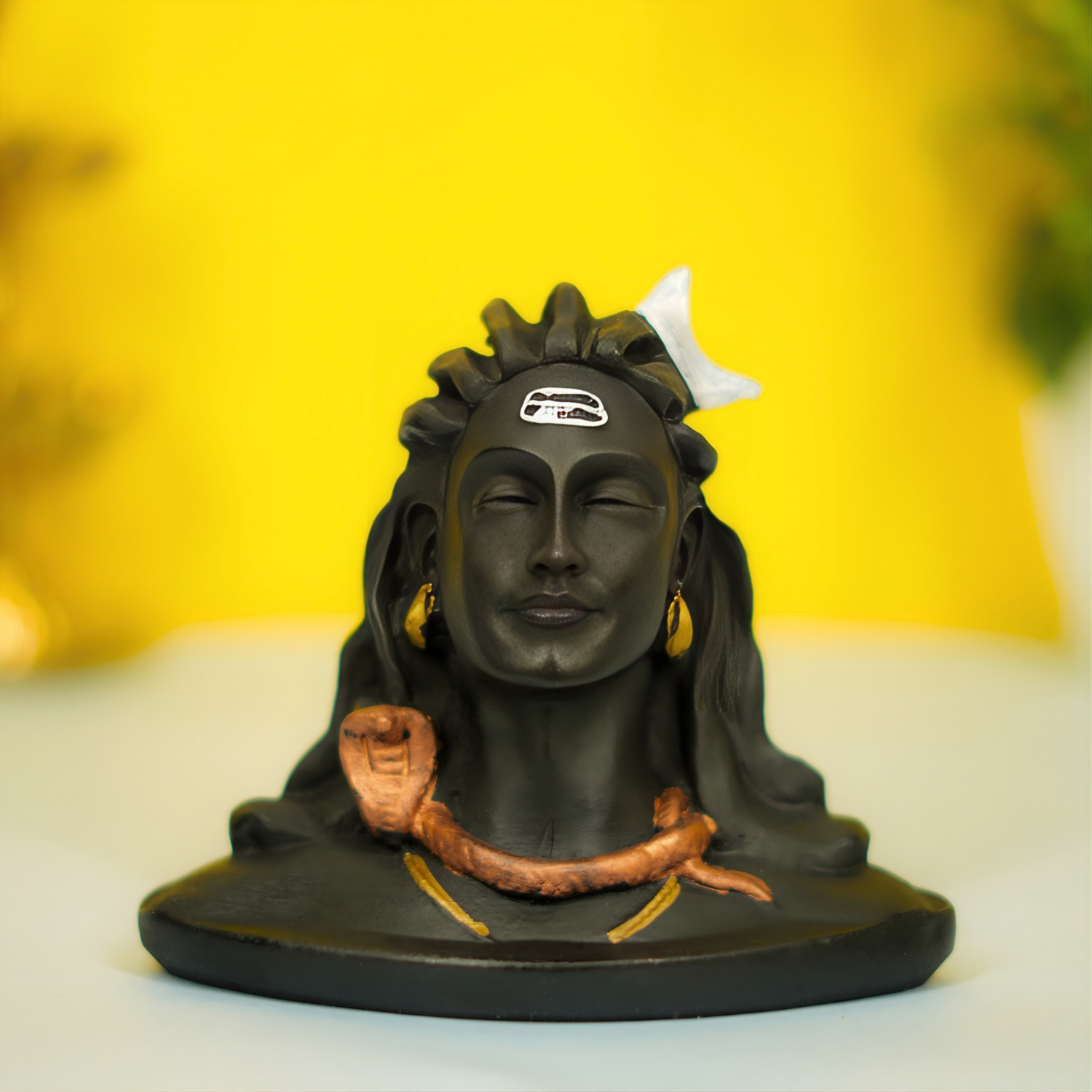 Black statue of a deity with a yellow background