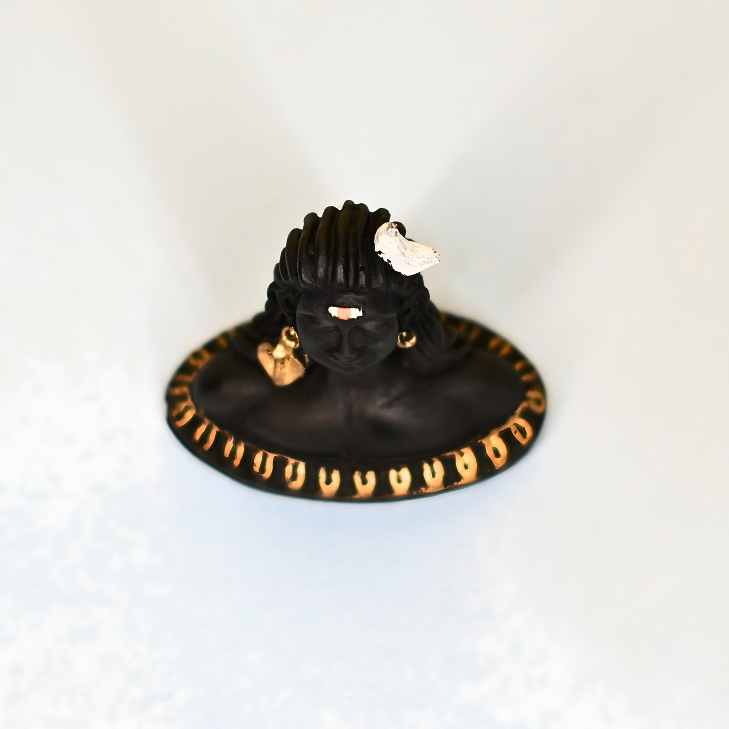 Black and gold car dashboard with a ring on a white background