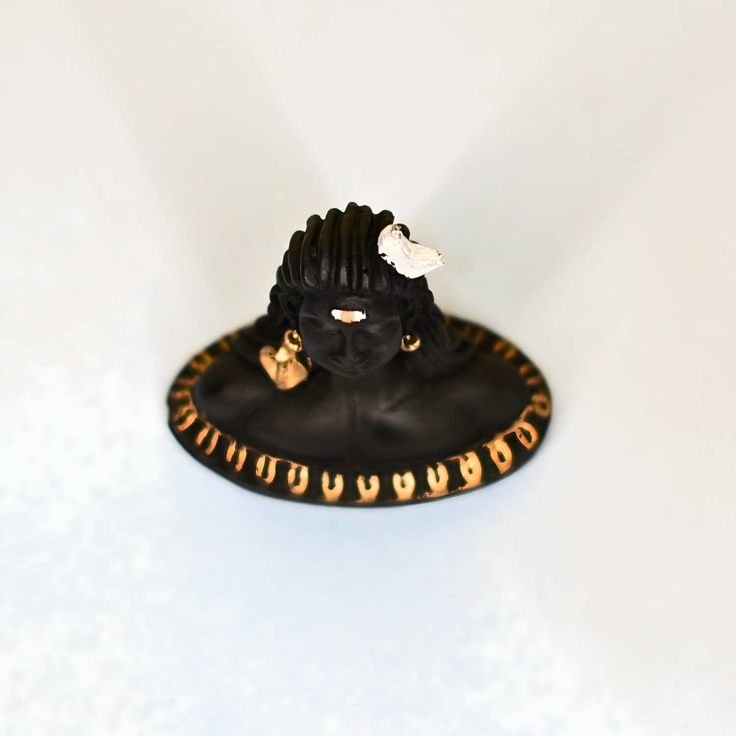 Black and gold car dashboard with a ring on a white background