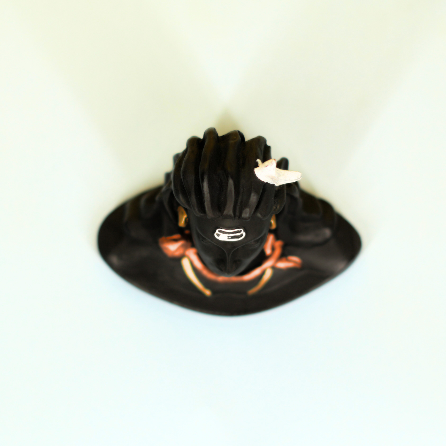 Black motorcycle helmet with orange accents on a white background