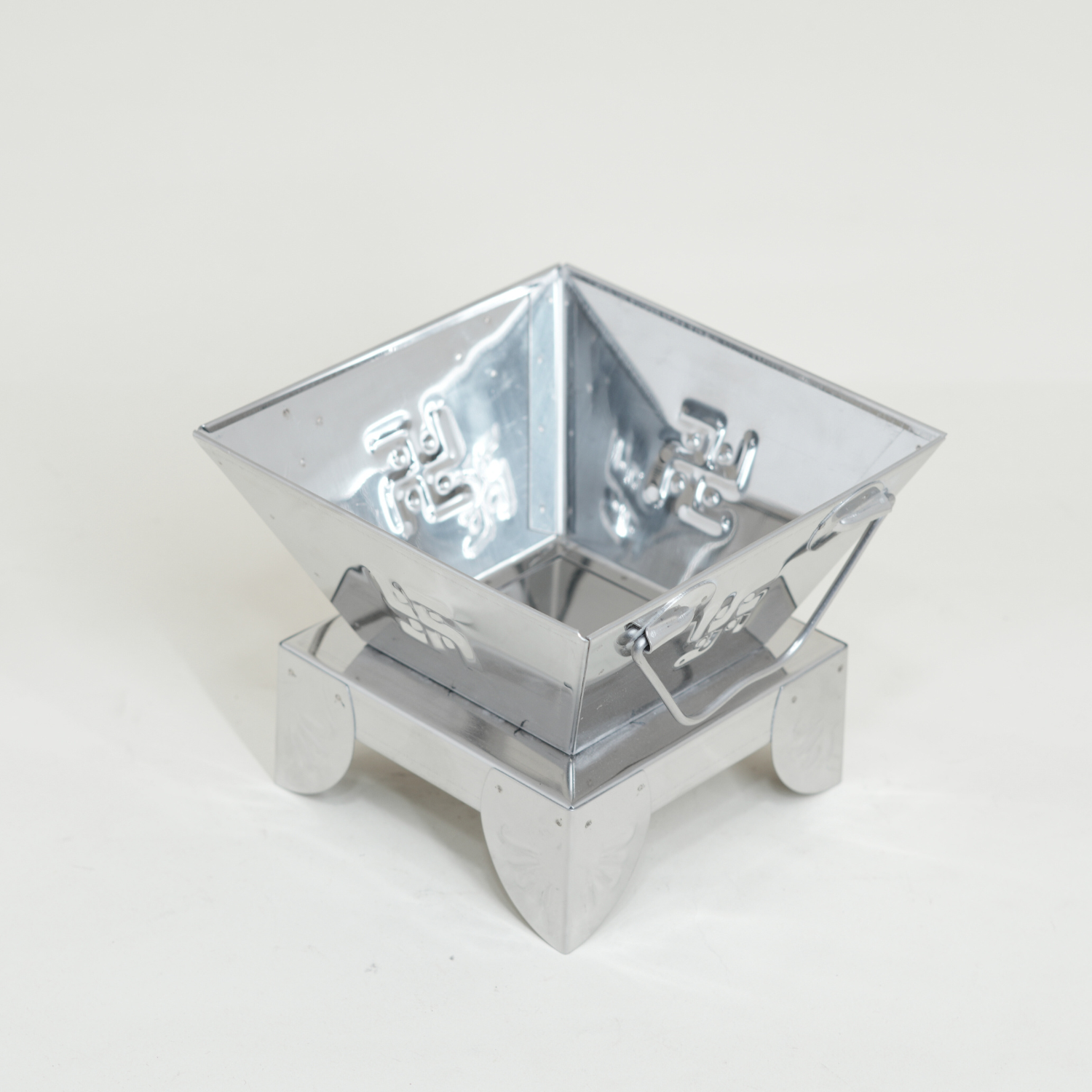 Metallic fire pit on a white background