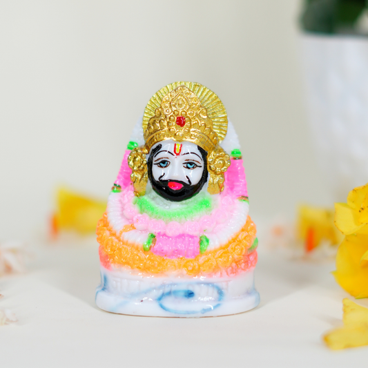 Colorful figurine with a gold headpiece on a white background