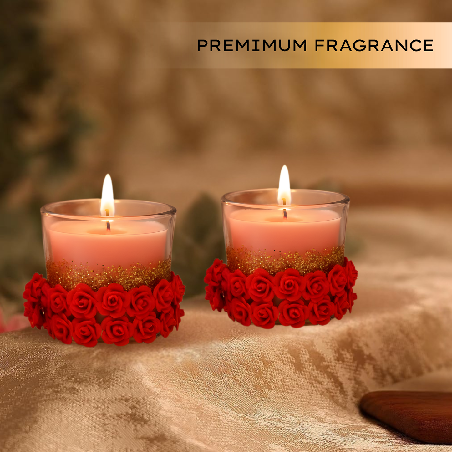 Two pink candles in red rose petal holders on a textured surface with 'PREMIUM FRAGRANCE' text above.