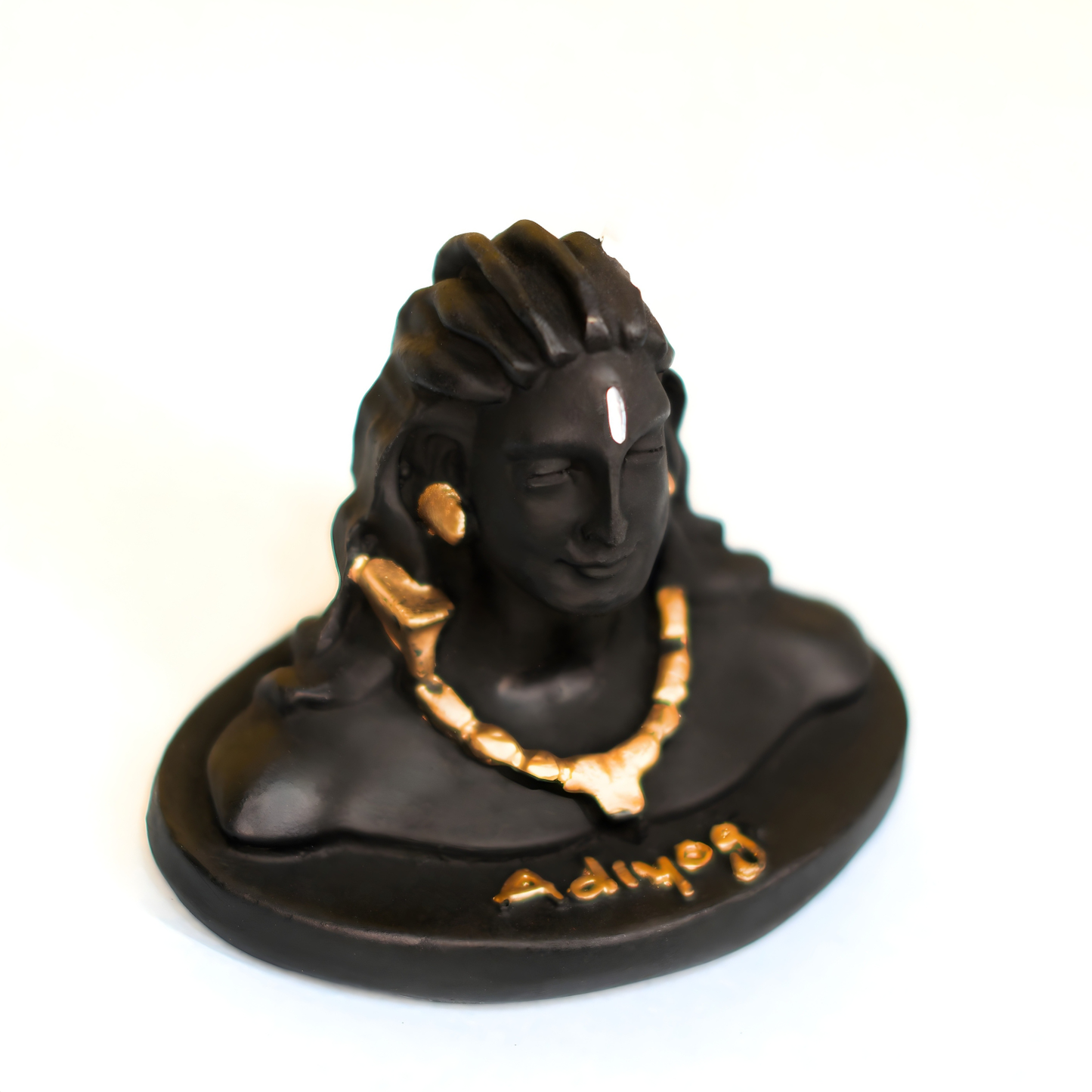 Statue of a adiyogi car dashboard statue with gold jewelry on a white background