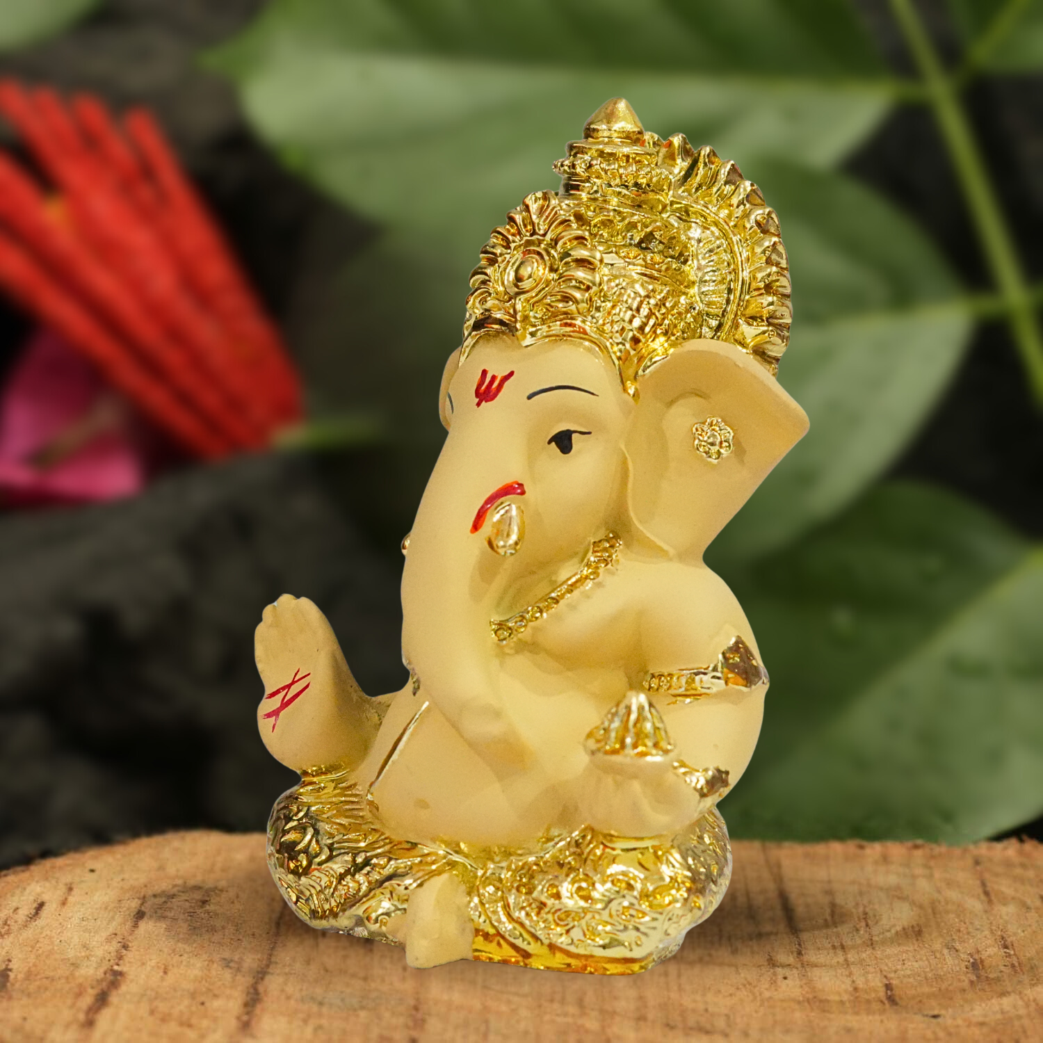 Decorative figure of a神灵 on a wooden surface with a blurred natural background