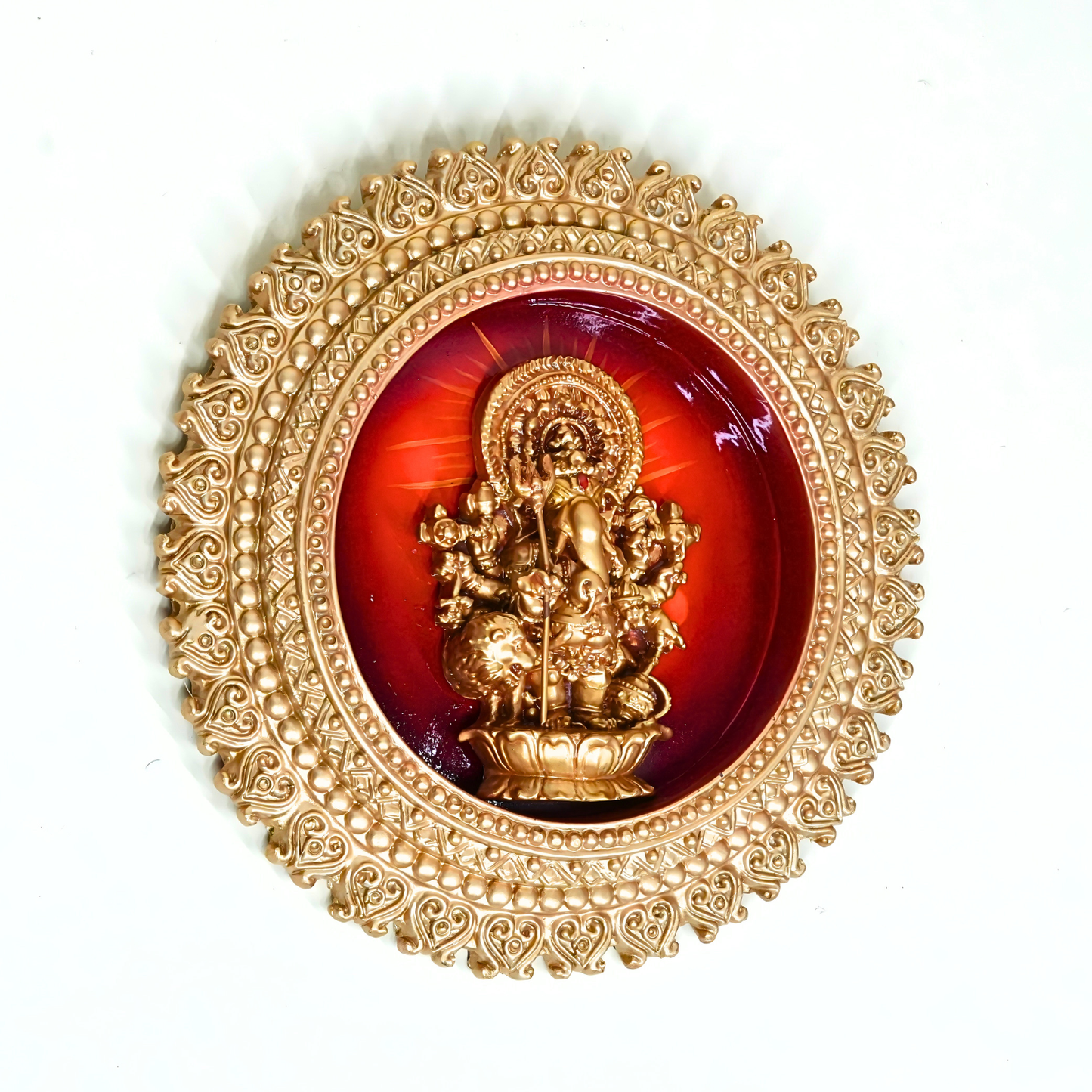 Decorative item with gold frame and red center featuring a central figure on a white background