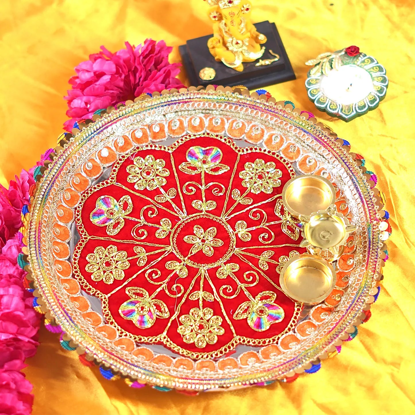 Decorative plate with gold and red design on a yellow background